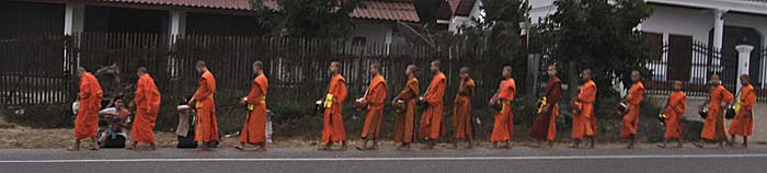 Monks in the morning streets of Luang Prabang by Asienreisender